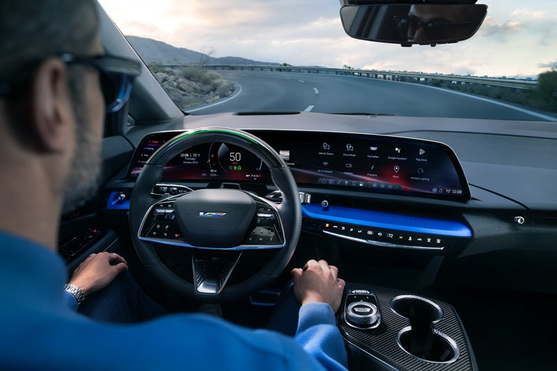 Front View of the 2026 OPTIQ-V Driving Through the Dusk Utilizing its Headlights | D'Addario Cadillac in Shelton CT